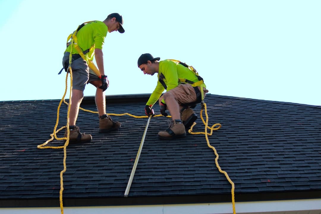 Roofers installing shingles